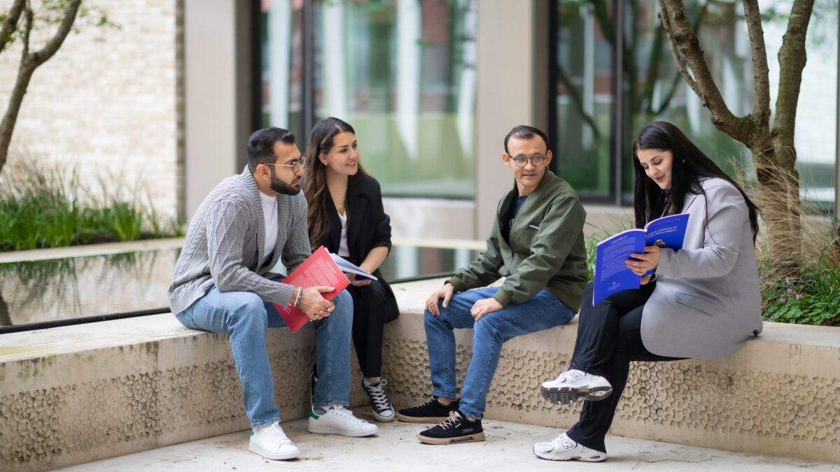 Farhad Daftary Doctoral Scholarship. Group of students sitting outdoors.