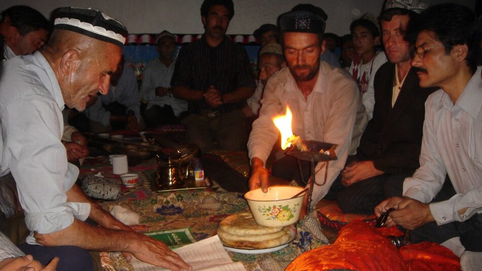 Ismaili Tajik men gathered around ritual fire in Xinjiang