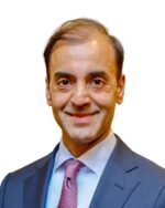 Fayyaz Nurmohamed in suit, against a white background.