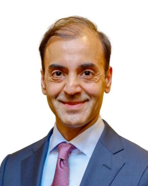 Fayyaz Nurmohamed in suit, against a white background.
