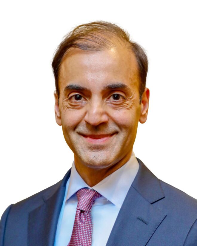 Fayyaz Nurmohamed in suit, against a white background.