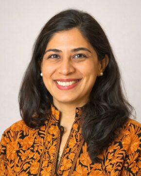 Professor Shenila Khoja-Moolji in embroidered orange attire.