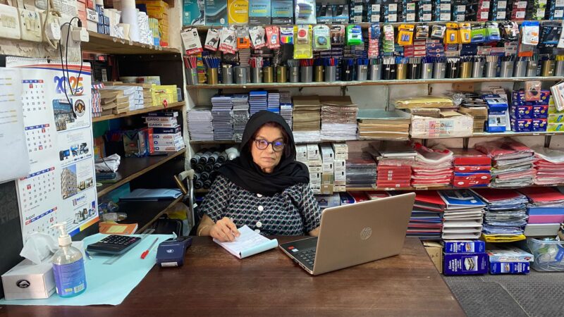 Naseem Baloo at her desk with office supplies. Oral History Project.