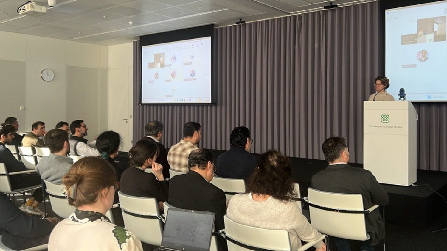 Audience seated at a lecture at the Aga Khan Centre as Dr Tatiana Korneeva presents slides during an IIS research seminar.