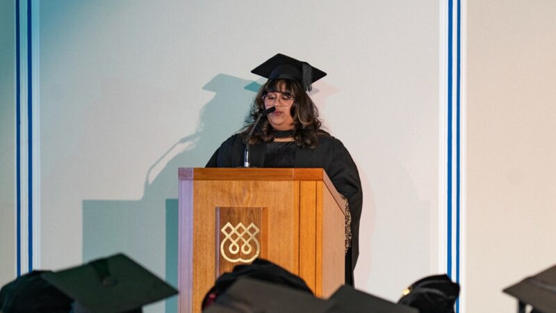 Nabila Esmail delivering a speech at graduation
