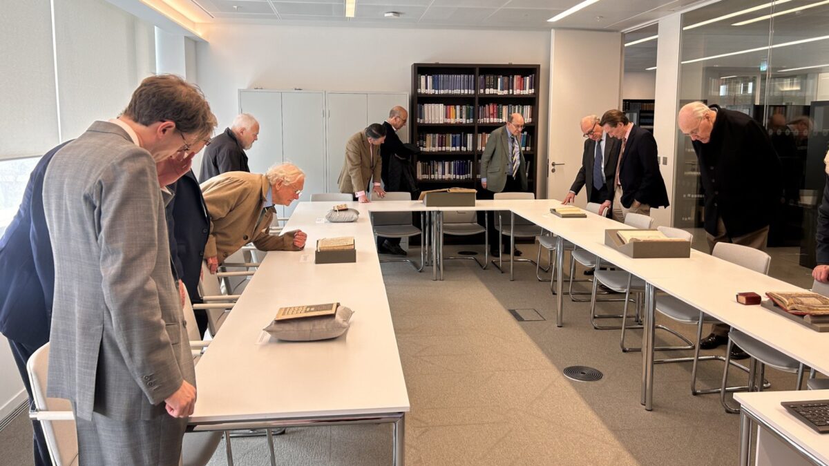 Members of The Travellers Club examine rare manuscripts and historic materials during a guided session at the Aga Khan Library.