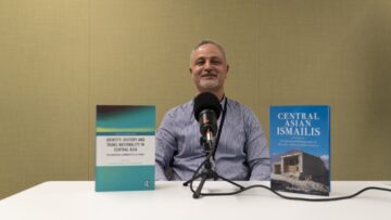 Dr Dagikhudo Dagiev seated at a podcast recording desk with two of his published books on Central Asian Ismailis