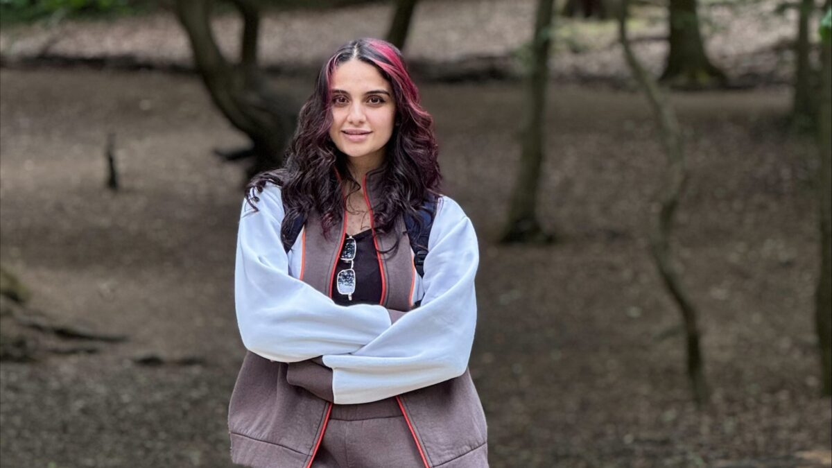 Faten Ghaibour, a STEP student-teacher standing in Queen's Wood during the outdoor learning workshop.