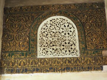 A richly decorated mihrab with pierced stucco work and gilded ornament at al-Azhar Mosque, Cairo.
