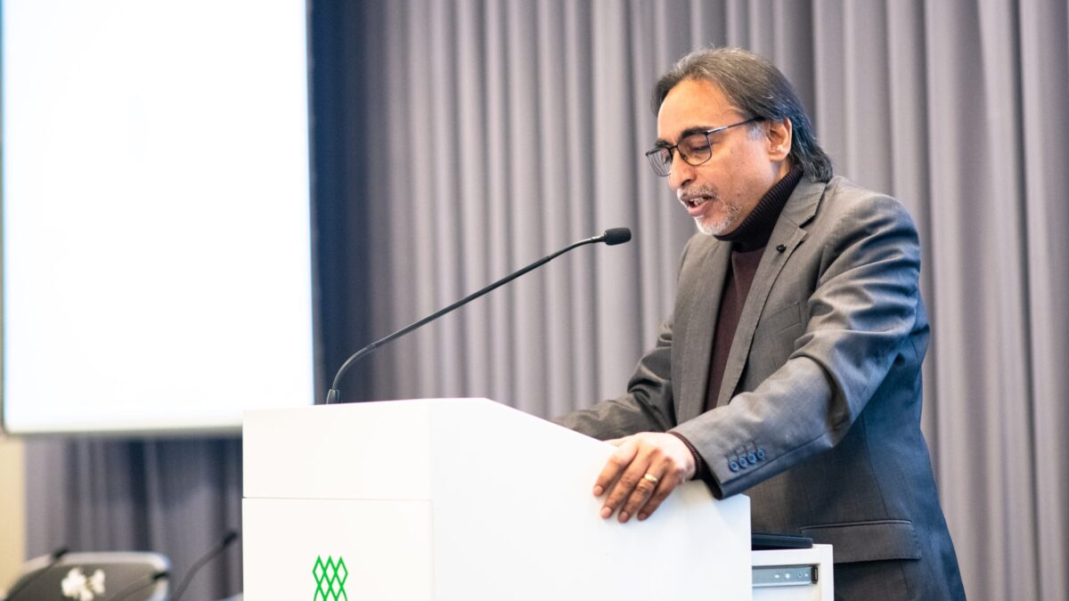 Hussain Jasani, Head of the South Asian Studies Unit at IIS, making opening remarks at a lectern.