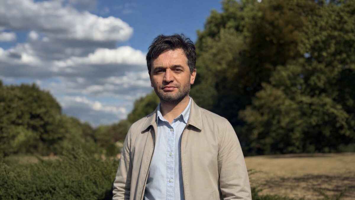 Hidoyatullo Shozodamamadov standing outdoors in a park on a sunny day.