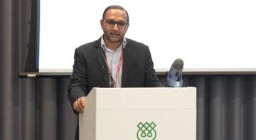 Dr Kumail Rajani speaking at a lectern during the IHTLS lecture on textual foundations of Fatimid law at the Aga Khan Centre.