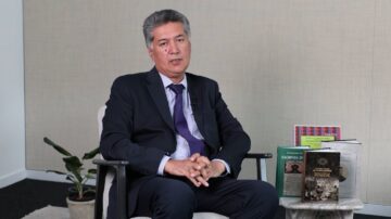 Safe: A speaker talks to camera in a studio, seated beside books including Russian Scholars on Ismailism.